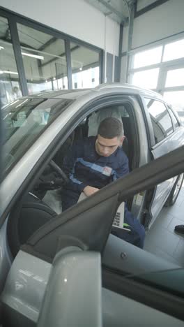 car mechanic using laptop for diagnostics