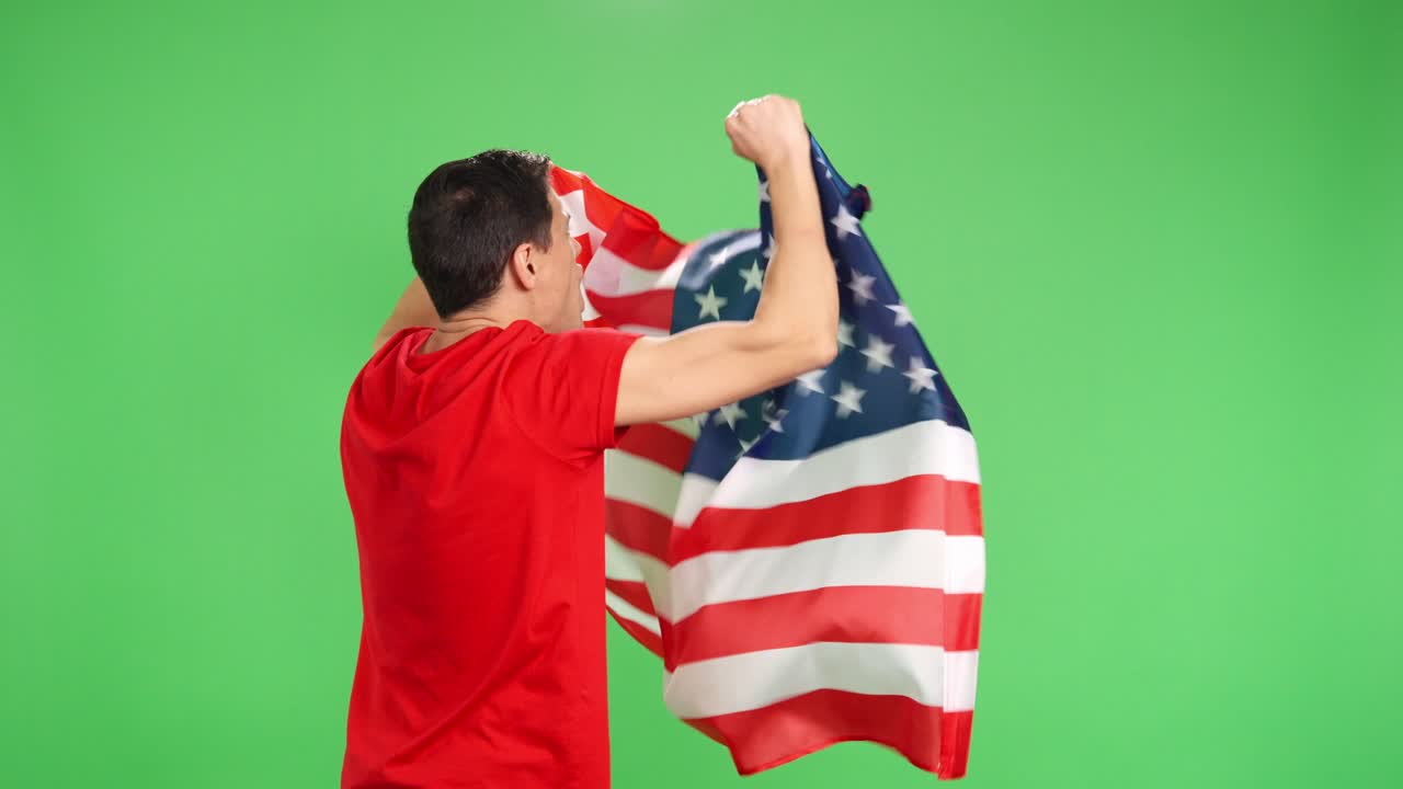 Man with his back turned waving american flag