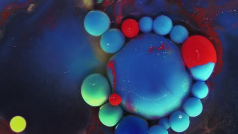 colorful bubbles. abstract blue, red, green mixture on a dark background. artistic color paint background.