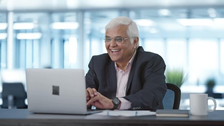 Happy senior Indian manager doing a video call