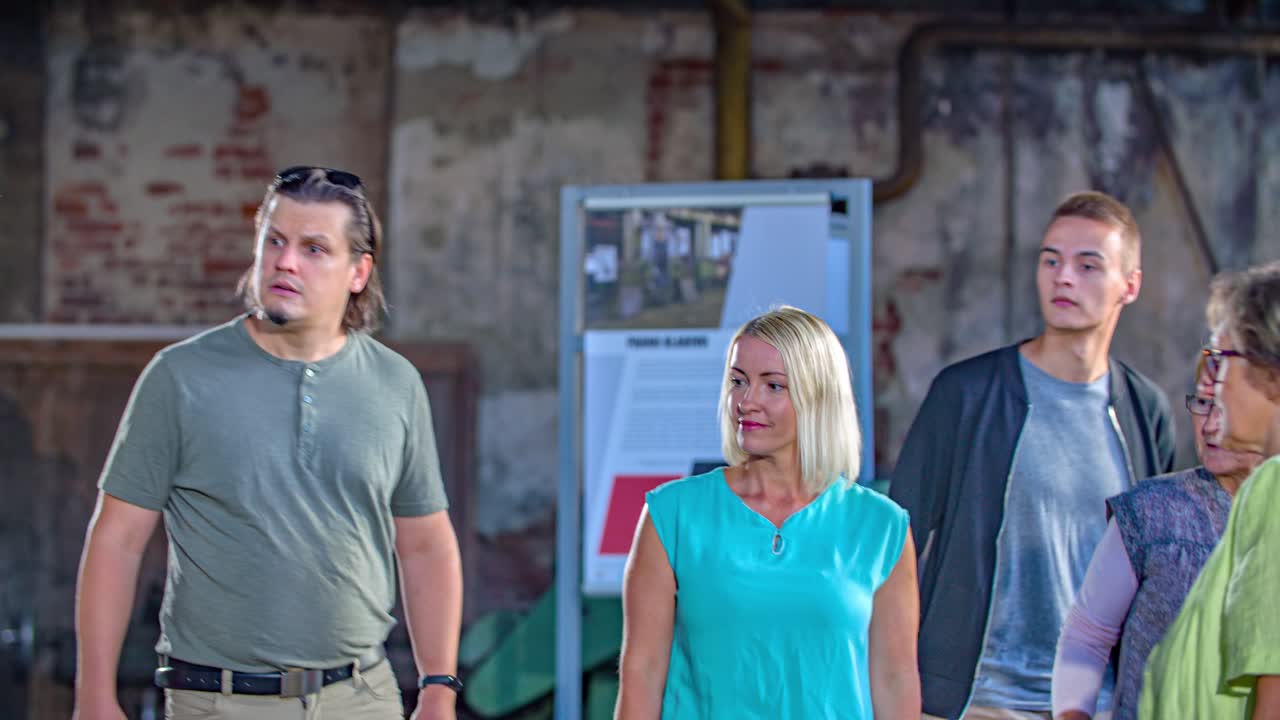 Group portrait of friends walking together with guide at museum, dolly