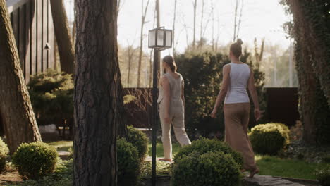women walking through a garden