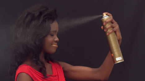 woman putting hairspray on herself