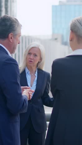 business professionals engaging in an outdoor discussion
