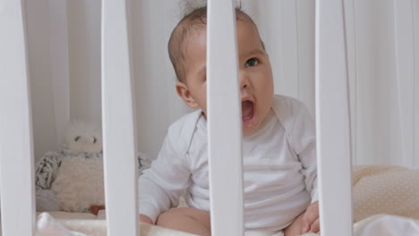 happy baby in crib cute toddler in cot smiling happy playful infant looking curious enjoying childhood life safe at home