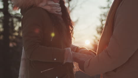 couple holding hands in winter sunset