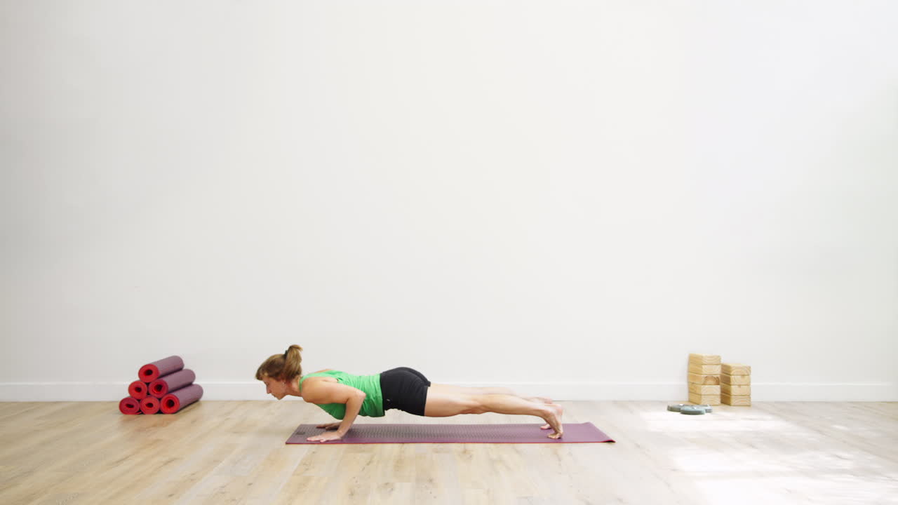 Woman Performing Yoga Sequence with Downward Dog, Plank, and Upward Dog