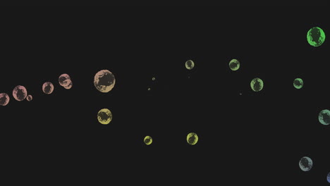 animation of multiple green and yellow bubbles floating across black background