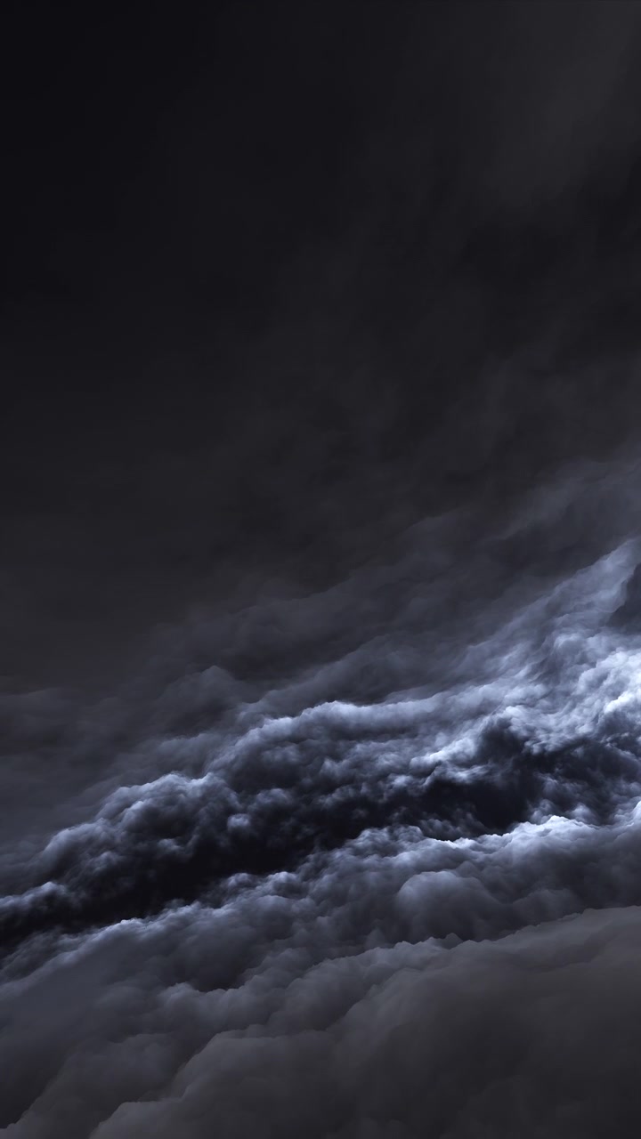 Ethereal, slow-moving dark clouds swirling with a dramatic blue-grey rim light. Ideal moody background for ambient music videos, luxury brand promos, and meditative visuals.