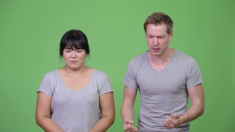 young multi-ethnic couple getting bad news together