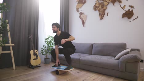 men on deck for balance stands with his feet, keeps his balance at home