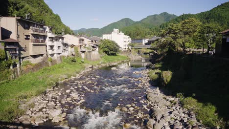 sunset over yoshida river running through gujo hachiman town, rural landscape