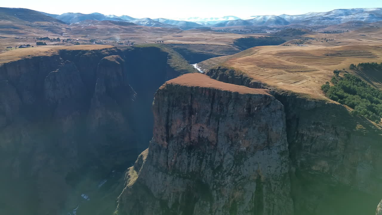 Luftfoto med drone over dramatiske kløftklinter og bjergplateauer i Lesothos højland, der viser det barske terræn og afsidesliggende afrikanske landskab.