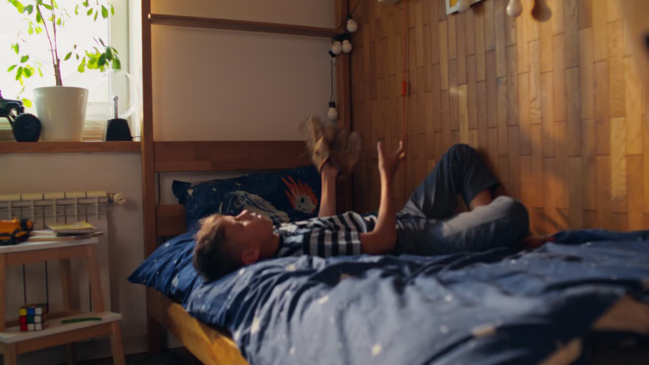 Boy playing in his bedroom