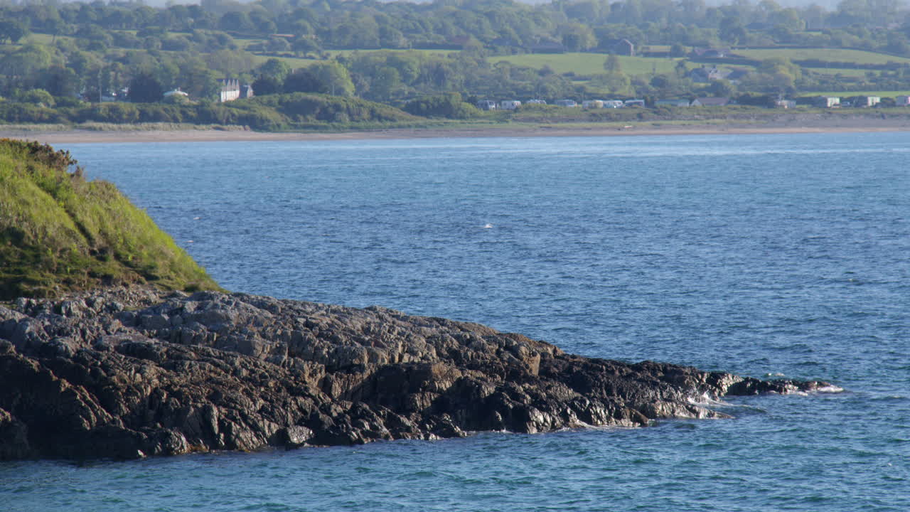 Mid shot Looking north on the rocky Shoreline at Hafan y Môr on Pen-y-chain, Pwllheli