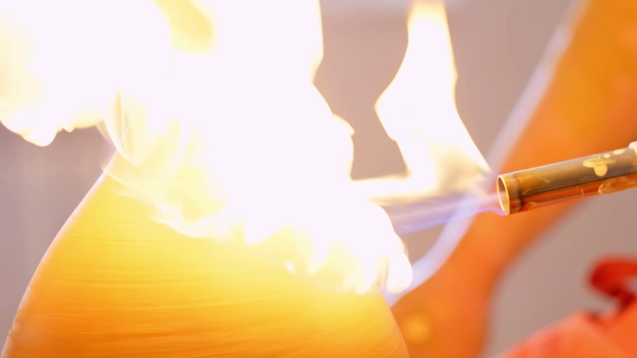 Artistic Techniques in Pottery: The Process of Shaping and Finishing Clay with Precision Using a Torch for Smooth Surface and Unique Texture Creation
