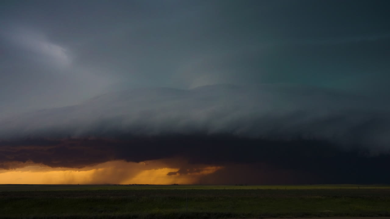 Fiery sunset colors under a threatening severe thunderstorm