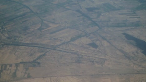 hazy aerial view of agricultural fields and rural landscape