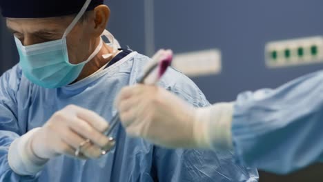 Close-up-of-doctor-using-medical-scissors