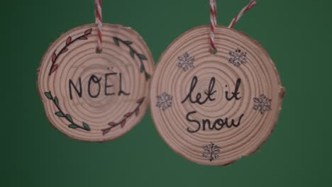 hanging wooden christmas decorations saying noel and let it snow