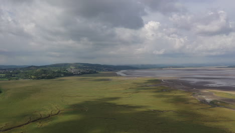 Aerial-shot-of-the-bay-on-the-west-coast-of-England-with-the-tide-out,-bright-summers-day