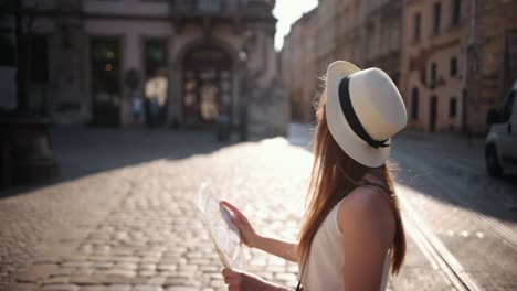 woman traveler girl searching right direction on map, traveling along europe