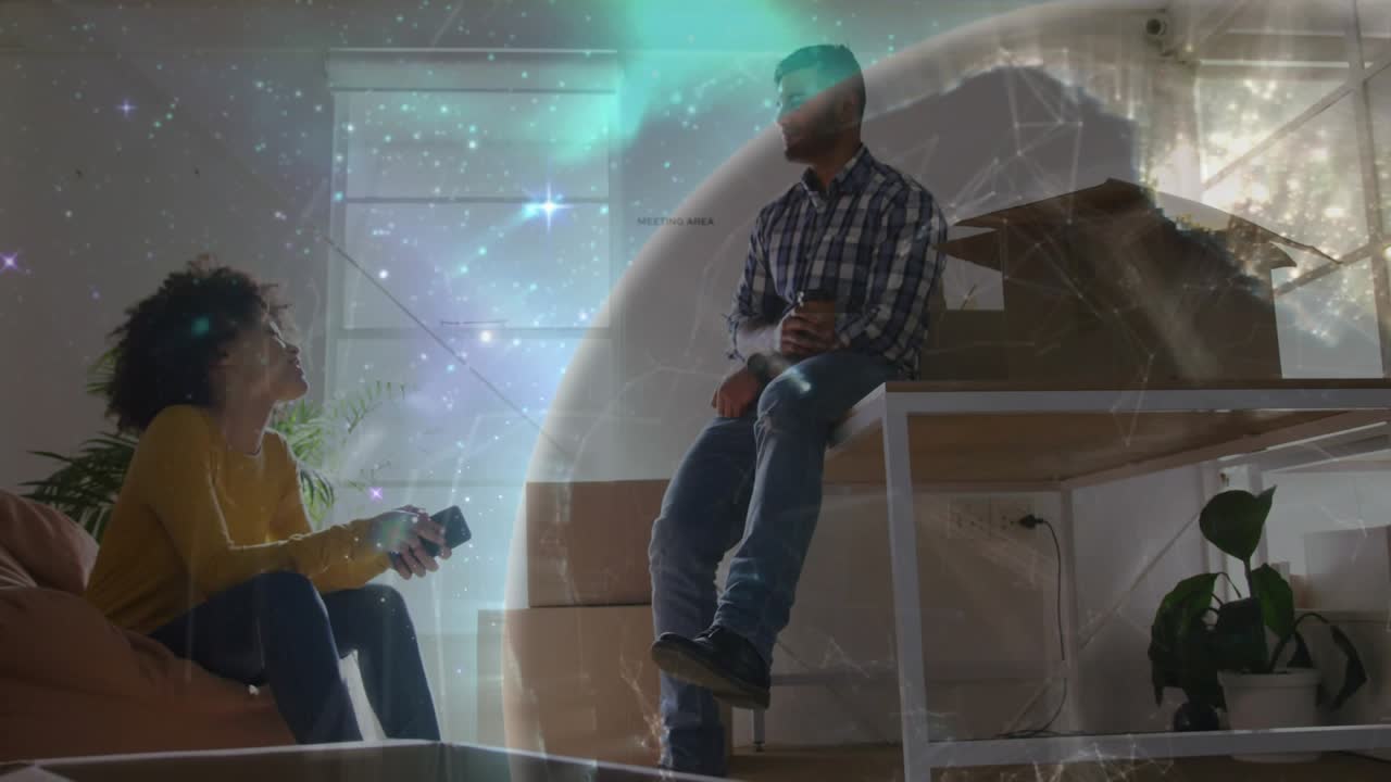 Woman showing smartphone to man, causing translucent planet overlay while couple planning home