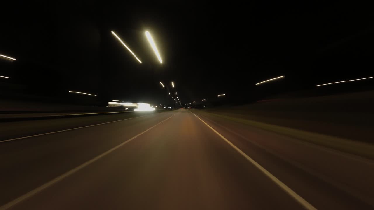 Fast night hyperlapse POV: Driving on highway through suburban night