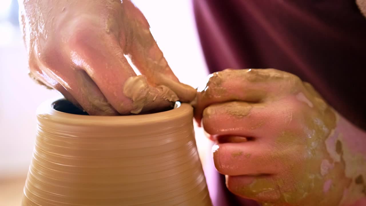 The Art of Pottery: A Craftsman's Hands Skillfully Shaping Clay into a Beautiful Vessel Reflecting Creativity and Tradition in the Pottery Studio