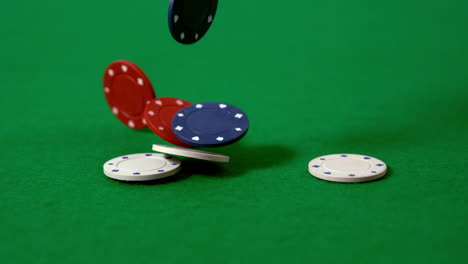 casino chips falling on green table