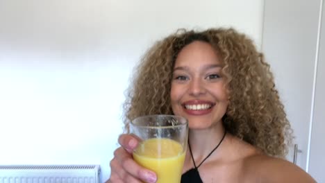 african american woman saying cheers on video call