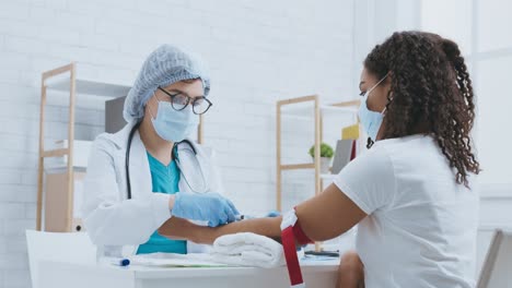 doctor performing blood draw on patient