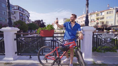 young man talking on video chat in the city.