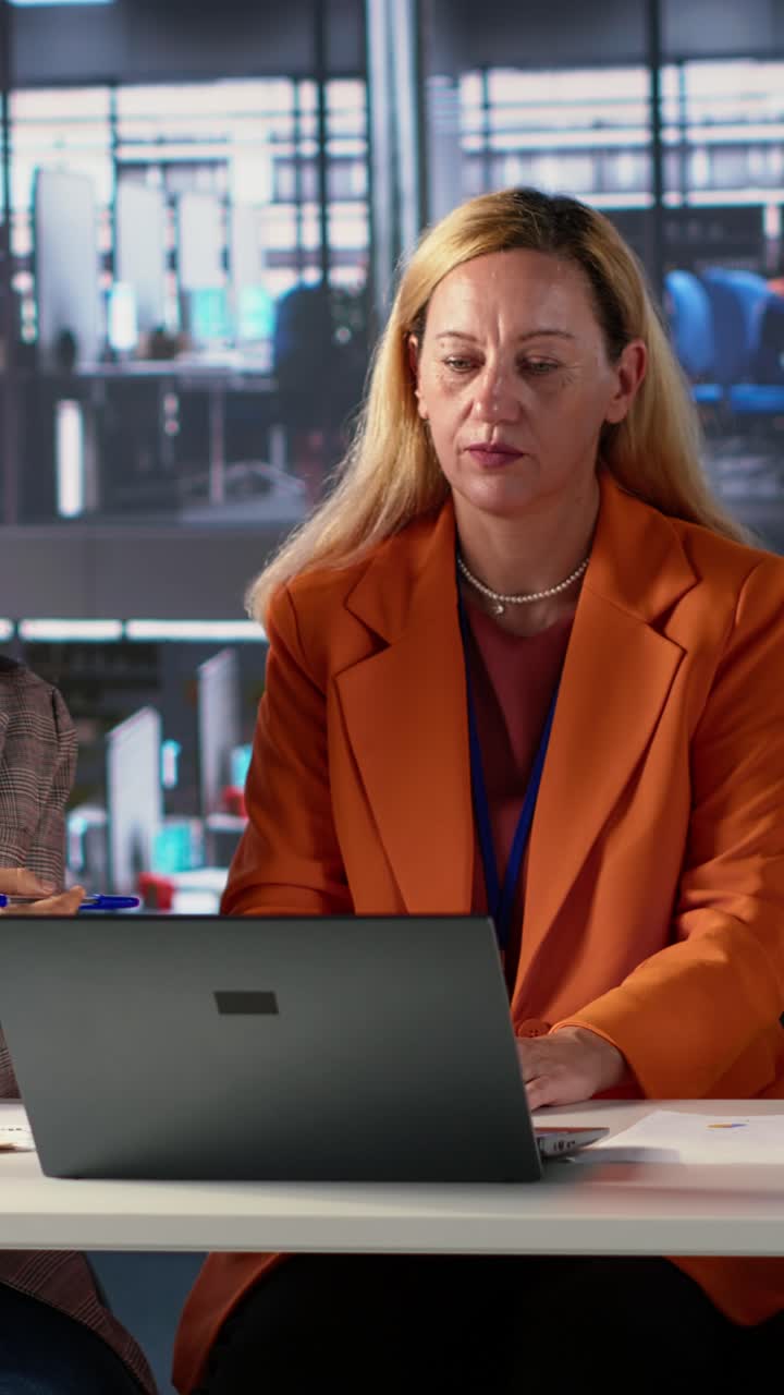 Professional Women Collaborating on Project at Office Desk