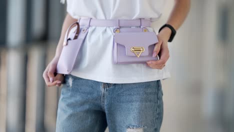 close-up of a waist-length purple micromusk on a girl in jeans and a white blouse