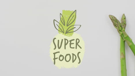 super foods text with green pineapple and asparagus animation