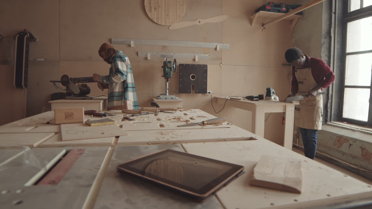 Two Handymen Working in Carpentry Workshop
