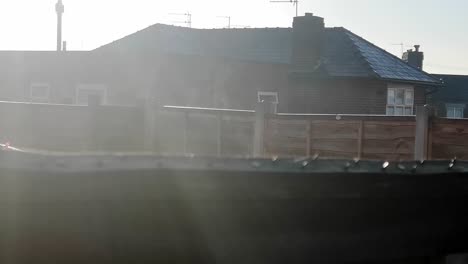 steaming garden fence panels warming in autumn sunrise