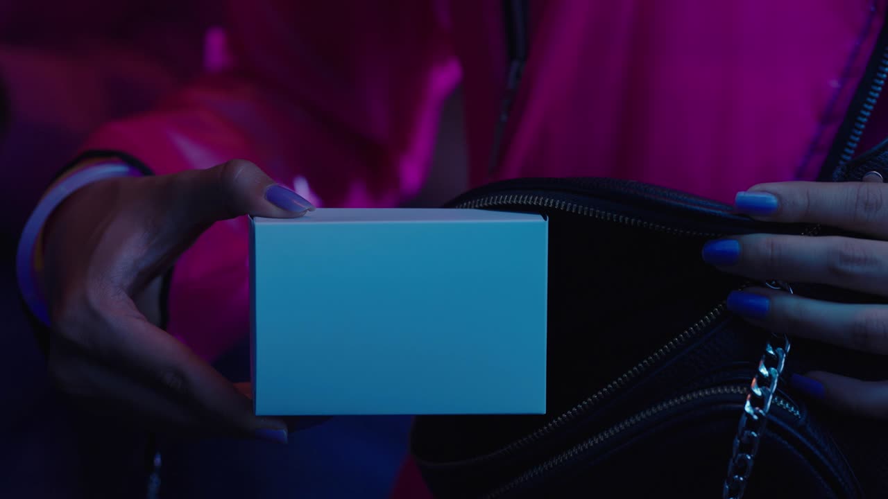 Taking out a white box from a bag at a music concert