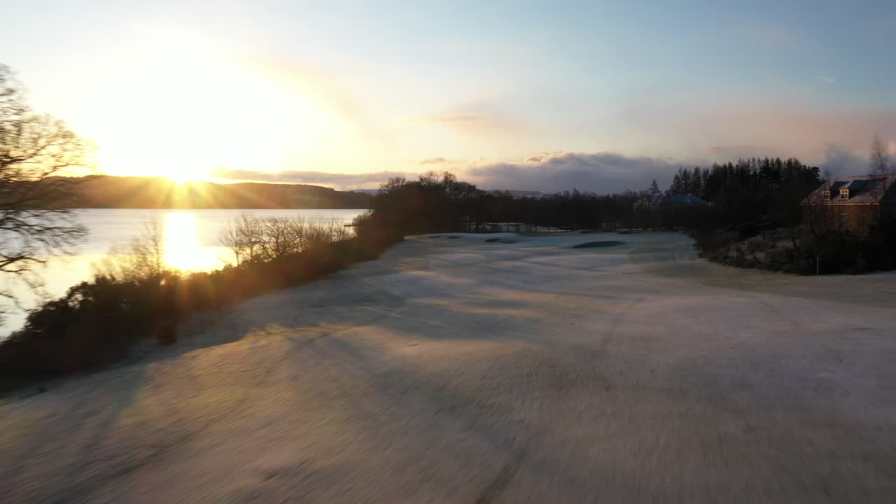 toma aérea de la calle del campo de golf al amanecer durante el invierno