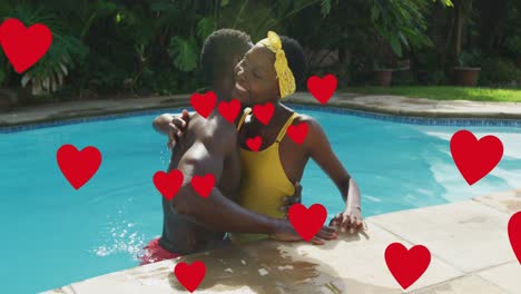 animation of heart icons over happy african american couple embracing