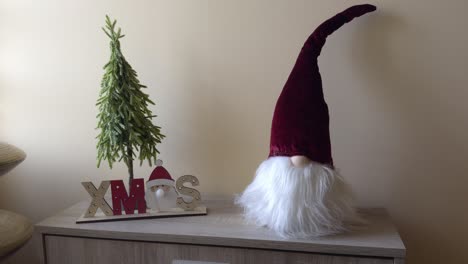 beautiful christmas decoration of bearded dwarf with red hat and small tree