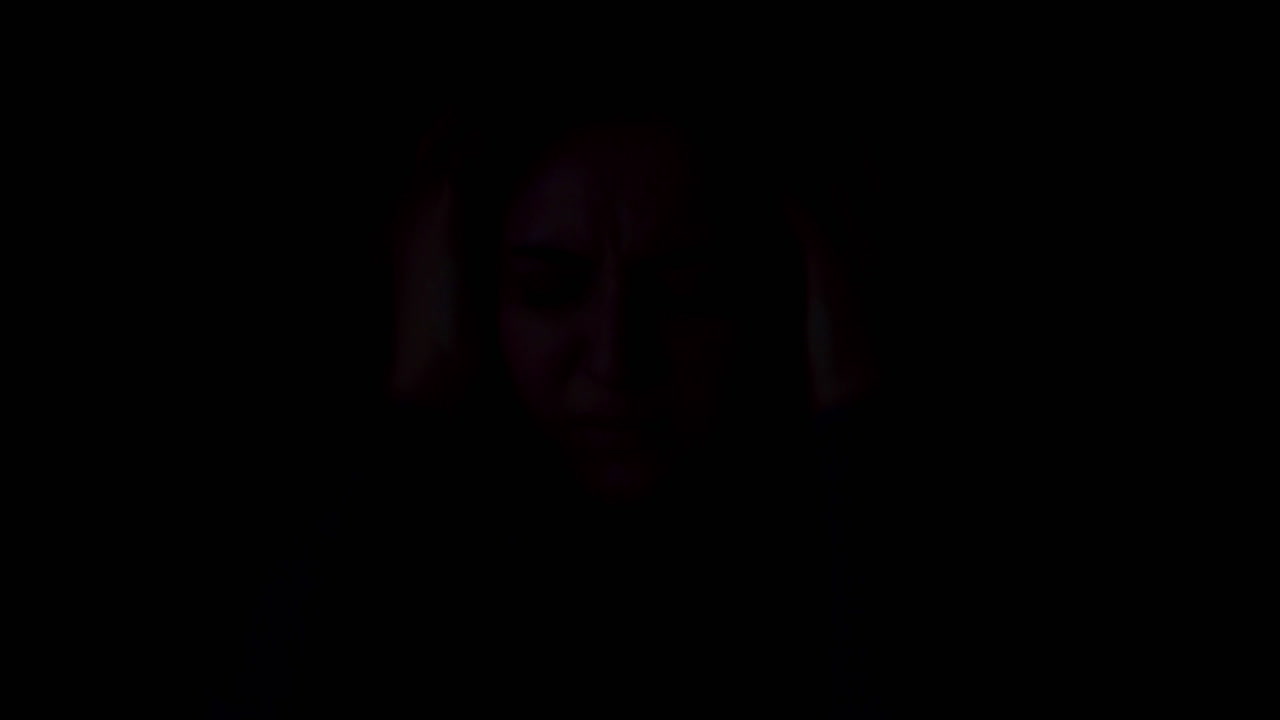 Terrifed woman in strobe light. Domestic violence victim