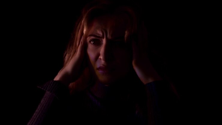 Terrifed woman in strobe light. Domestic violence victim