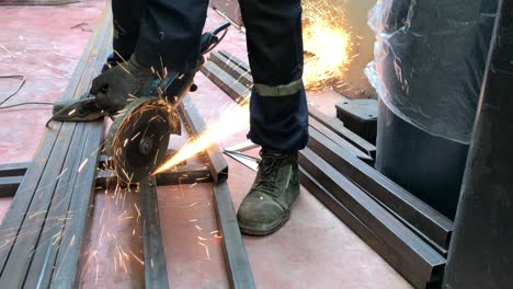 unrecognizable worker cutting iron with a radial