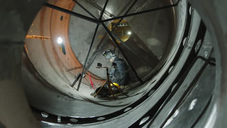 welding inside a large industrial tank