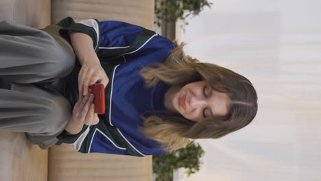 Vertical-video-of-The-young-woman-arguing-in-the-messaging-is-angry.