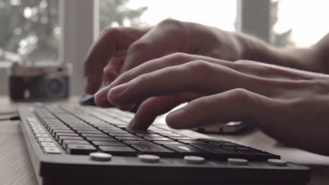 close up on typing on a keyboard. man typing on computer keyboard. mans hand using computer keyboard and mouse for typing. freelancer photographer working with computer.