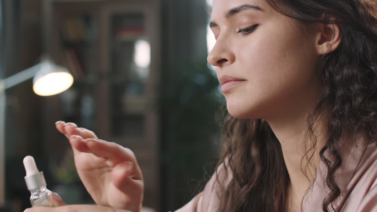 Woman Applying Hydrating Serum On Face