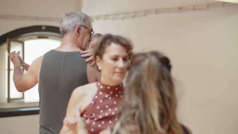 medium shot of senior couples dancing together in studio